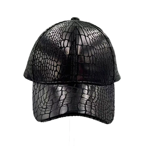 Detail view of black faux leather baseball cap with premium crocodile skin texture