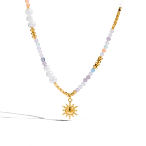 Boho style necklace with freshwater pearls, colorful beads and a golden sun pendant