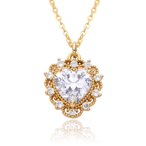 Detailed macro view of 18k gold heart pendant with white zircon and vintage hollow crafts