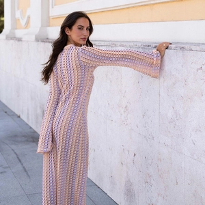 Detail of multi-color crochet maxi dress showing intricate hollow-out knit patterns