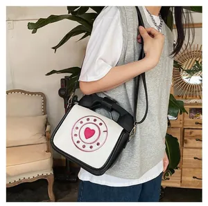 Creative vintage telephone-shaped crossbody bag featuring retro rotary dial and handset handle