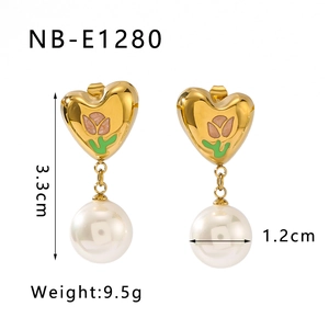 Detailed view of heart-shaped hoop earrings with pink enamel flowers and white pearl
