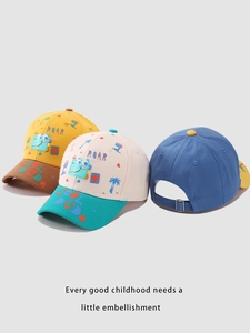 Detailed display of colorful kids dinosaur baseball caps with ROAR embroidery and metal buckles