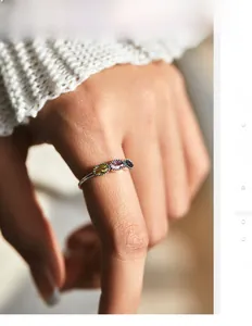 Macro detail of S925 silver ring featuring three colorful oval gems with retro beaded edges