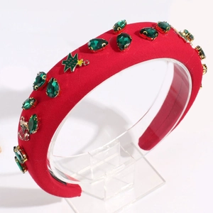 Macro detail of red padded headband with green teardrop gems and Christmas tree charms