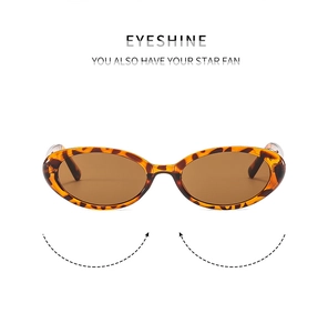 Detail of oval sunglasses featuring classic tortoiseshell frames and brown lenses