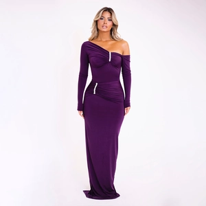Detail of purple one-shoulder evening gown with long sleeve, ruching, and rhinestone buckle