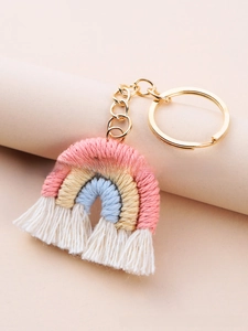 Macro detail of handmade bohemian rainbow keychain with colorful cotton rope and white fringe