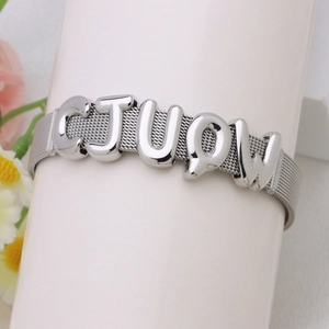 Silver woven mesh bracelet with polished metal bubble letter charms CJUQ on display