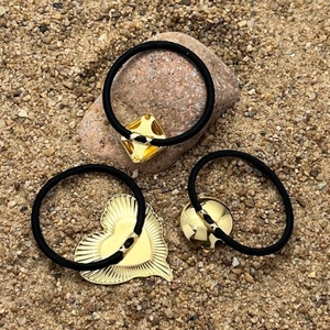 Three-piece set of elegant gold metal hair ties in square, heart, and round shapes
