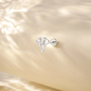 Detailed macro of 925 sterling silver cartilage stud with drop-shaped crystal tassels