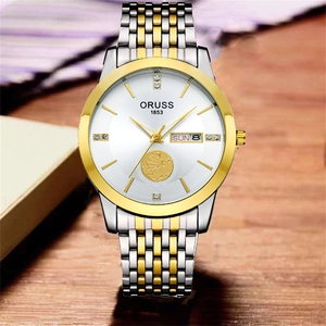 Detail of ORUSS watch face with golden sailboat relief and dual calendar display