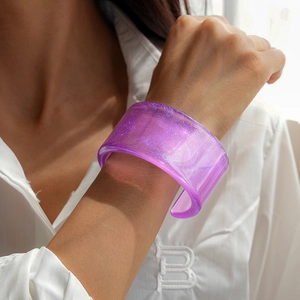 Detailed macro view of purple resin cuff bracelet with sparkling silver glitter finish