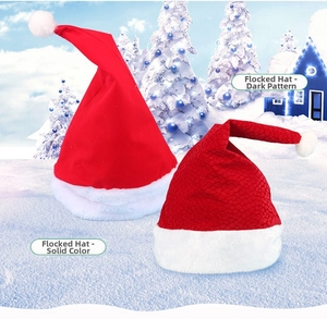 Detail of red velvet Christmas hats with solid flocking and embossed patterns on snow