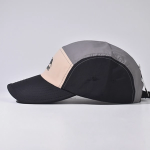 Detail of multi-color five-panel outdoor cap with mountain print and adventure logo