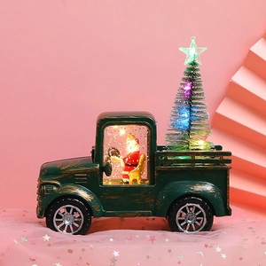 Vintage green Christmas tractor with Santa Claus and glowing colorful tree decoration