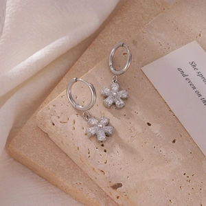 Elegant silver flower drop earrings with zircon petals on a textured stone base