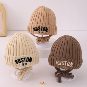 Detailed texture of ribbed knit beanies with BOSTON embroidery and earflaps