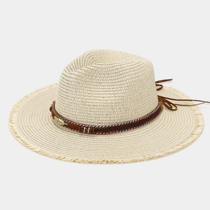 Detail of straw hat featuring ethnic bands, colorful beads, and a gold feather charm