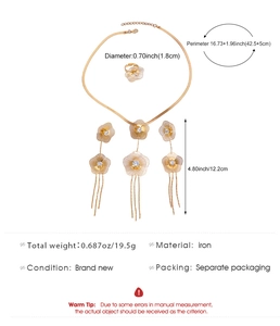 Detailed view of golden iron jewelry set with hollow flower pendants and tassels