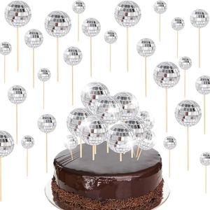 Sparkling silver disco ball cake toppers in various sizes on a chocolate cake