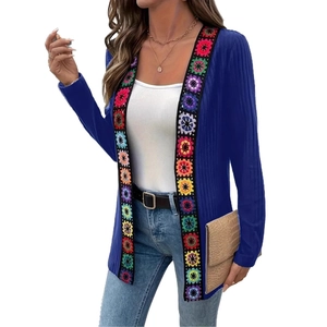 Detail of bohemian knit cardigan with colorful floral embroidery and ribbed texture