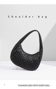 Detailed view of black woven leather shoulder bag with crescent shape and metal zipper
