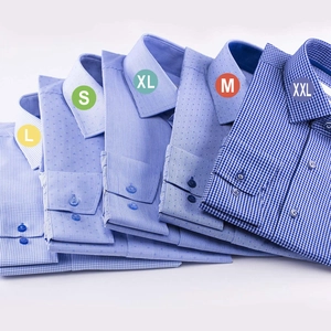Adhesive blue shirt size stickers L S XL M XXL on folded cotton striped button-down shirts
