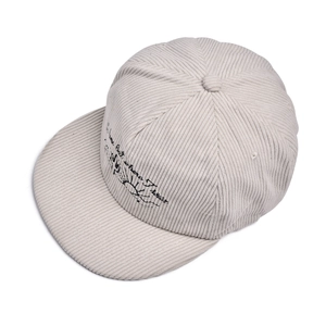 Detail of No Home But Where I Roam text embroidery on corduroy flat brim baseball cap