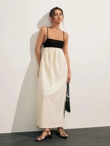 Detailed side view of black and white color block maxi dress with backless design