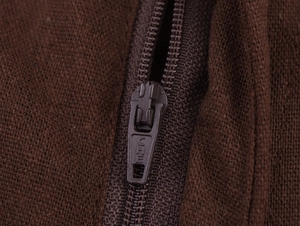 Macro detail of high-quality metal zipper on dark brown knitted trousers with CHE engraving