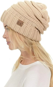 Close-up of beige cable knit beanie with foldable brim and brown C.C leather patch