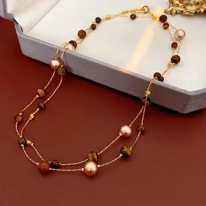 Vintage double-layer necklace with tiger eye stone and pearls on gold-tone metal chain