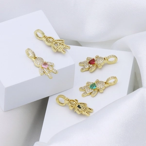 Detailed close-up of gold-plated boy and girl pendants with colorful heart-shaped zircons