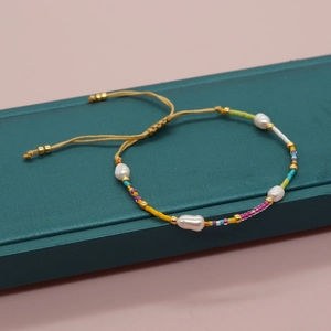 Detail showing natural freshwater pearls and colorful seed beads on an adjustable cord