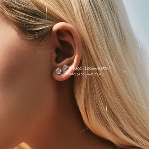Moissanite 925 sterling silver stud earrings in 0.5ct and 1.0ct sizes on model