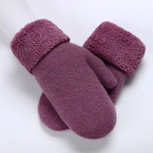 Close-up of purple knitted mittens with thick plush cuffs and soft warm wool texture