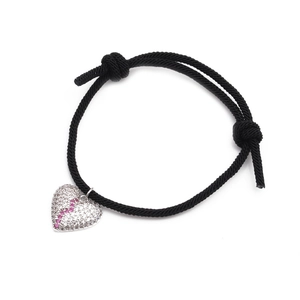 Detailed view of woven heart charm bracelet featuring inlaid pink and white zircons