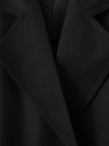 Close-up of a black casual blend coat showing the sharp twill fabric and lapel collar detail