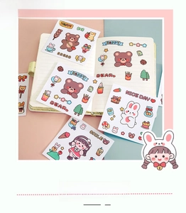 Close-up of cute cartoon bear and rabbit PVC stickers on a notebook for DIY decoration