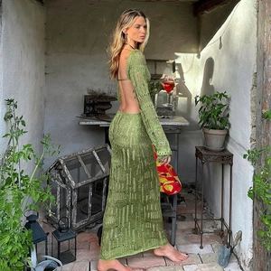 Close-up of hollowed-out texture on the green backless knitted maxi dress for summer