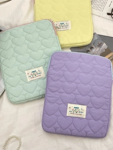Quilted heart pattern laptop sleeve in yellow, green, and purple with zipper closure