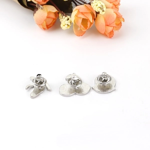Back view of fruit pins featuring banana, cherry, peach shapes with butterfly clasps