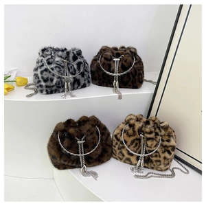 Close-up of leopard print faux fur bucket bags with metal ring handles and tassel details