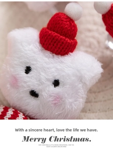 Close-up of white plush Christmas bear with a red knitted hat and cute embroidered details