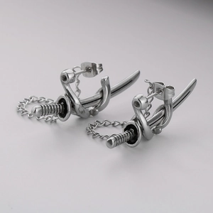 Macro shot of silver samurai sword earring with chain detail and metallic finish