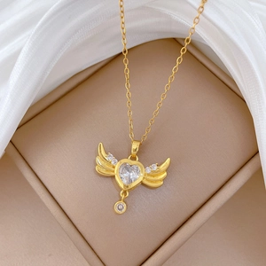 Golden heart wing tassel necklace with sparkling zircon on premium white silk background