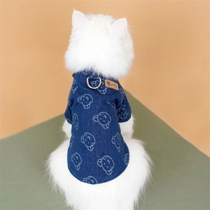 Detail of dark blue denim pet vest with white bear prints and metal D-ring for leash attachment