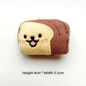 Close-up of toast bread plush pin with cute embroidery, 4cm height and 5.5cm width