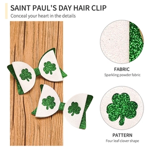 Detail of St. Patrick's Day glitter bows with green four leaf clover patterns on wood background